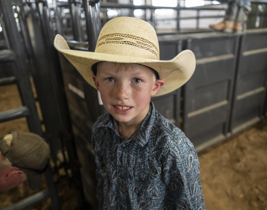 8-year-old Levi Fletcher of Leggett, Texas was excited to compete calf riding at  the Bill Pickett Youth Rodeo, held at the Williamson County Expo Center  on Saturday, June 21, 2025.  His cousin, 5-year-old Colt Fletcher,  was also competing.   Now in its second year, the rodeo showcases athletes 18 or younger. The event is coordinated by the Bill Pickett Youth Rodeo Association.     Photo by Andy Sharp.