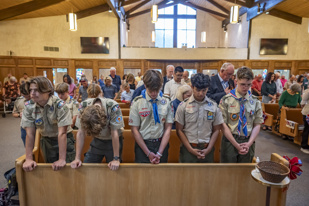 Scouts with Scouting America Troop 405 join others in prayer during  the Eagle Scout Court of Honor  for Trevor Suggs.