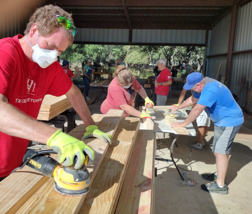 Ben Lake works a sander, smoothing a 2-by-6 piece of pine during a September 21 Sleep in Heavenly Peace bed-building day in Georgetown. Photos by Brad Stutzman