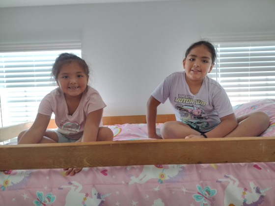 Rebecca Pola’s nieces, Ellie and Delilah Cardenas, enjoy the view from a top bunk.
