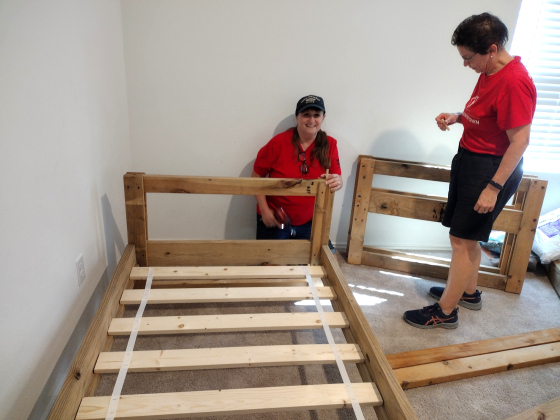 Myra Page, Evelyn Petrere and Ed Petrere attach a headboard during Sleep in Heavenly Peace’s September 28 delivery to the Pola family in Jarrell.