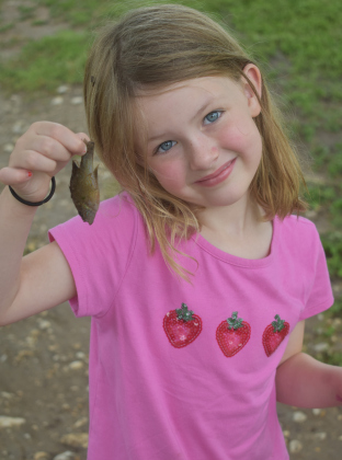 Five-year-old Josephine Linkenhoger and mom Daina Huntington were checking out the flood’s aftermath on San Gabriel Park Sunday afternoon. Josephine finds a small fish that washed up from the river. Photos by Katherine Anthony