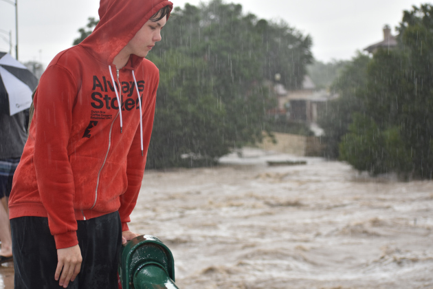 Hawkins Johnson, 16, takes a measure of the roaring San Gabriel River from the Austin Avenue bridge. Photos by Katherine Anthony