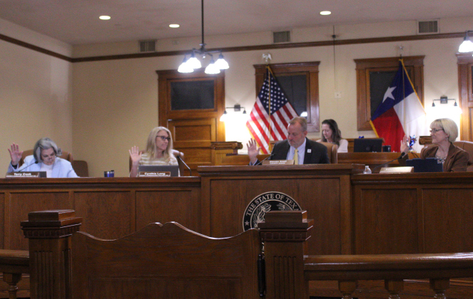 The Williamson County Commissioners Court, from left, Terry Cook, Cynthia Long, County Judge Steve Snell and Valerie Covey approve a two percent salary increase for elected officials during the July 29 meeting. Photo by Nalani Nuylan.