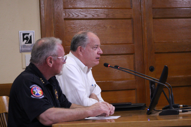Bruce Clements, from Wilco’s Office of Emergency Management (front) and Bob Daigh, senior director of infrastructure, give a damage report from the July 5 floods during the meeting. Photo by Nalani Nuylan.