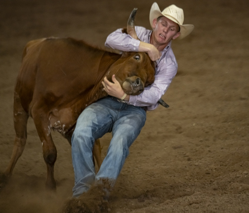 Craig Sciba of Victoria, Texas competes in Steer Wrestling  at the  75th Annual Taylor Rodeo on Thursday, July 17,2025.  Coordinated by the Taylor Rodeo Association, the three-night rodeo is held at the Williamson County Expo Center.   Photo by Andy Sharp.