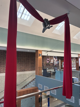  David Downing’s “Aerialist,” winner of the TSOS juror award hangs high above the Library lobby.