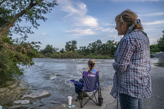 Friends Jaidy Alvarez, right, and Patrica Spivey enjoy some quiet fishing time at Mankins Crossing along the San Gabriel River on Tuesday, July 22, 2025. Recent flooding has made some areas difficult to access, but these friends found a quiet space to enjoy their pastime.   Photo by Andy Sharp.  