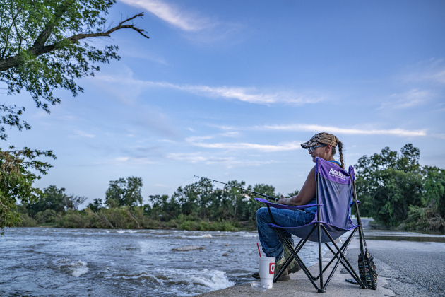Patrica Spivey enjoys some quiet fishing time at Mankins Crossing along the San Gabriel River on Tuesday, July 22, 2025. Recent flooding has made some areas difficult to access, but these friends found a quiet space to enjoy their pastime.   Photo by Andy Sharp.