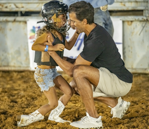 Capri Roselli, 7, is comforted by her father Chris Roselli after her Mutton Bustin’ ride.