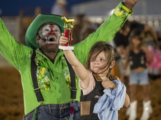 Indie Parnell, 5, with rodeo clown Leon Coffee, proudly displays her first place trophy for winning the Mutton Bustin’ competition. Indie also won first place in Mutton Bustin’ at the Bill Pickett Youth Rodeo in Taylor.