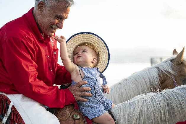 11-month-old Verlon Haire sits on a horse with his grandfather, Lee Brown, a member of the Williamson County Sheriff’s Posse Drill Team, just before granddad rode into the arena with team during the Williamson County Sheriff’s Posse Rodeo on Friday, June 27. (Photos by Andy Sharp)