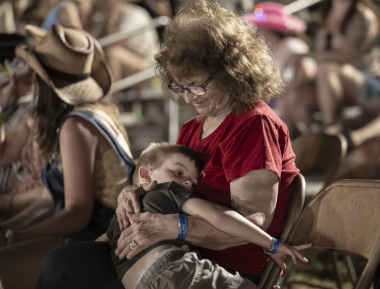 As rodeo action comes to an end, 3-year-old Logan Bonnell, feeling pretty sleepy, found comfort in the arms of his grandmother, Karen Chase.