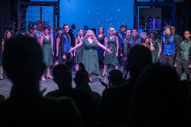 Sage Hickman, center (with arms out) playing Carole King, joins cast members in a closing  scene from “Beautiful: The Carole King Musical” on Thursday, July 24, 2025.  The production runs through August 31st on the Georgetown Palace Springer Stage.   Photo by Andy Sharp.