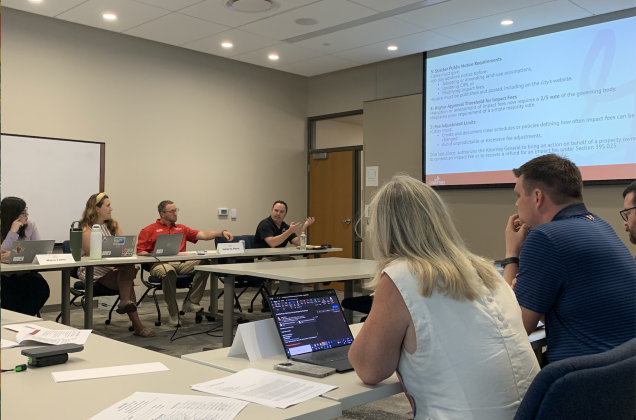 Georgetown Systems Engineering Director Wes Wright, middle, answers a question about impact fees during a special city council meeting on July 16. (Photo by Kaitlyn Wilkes)