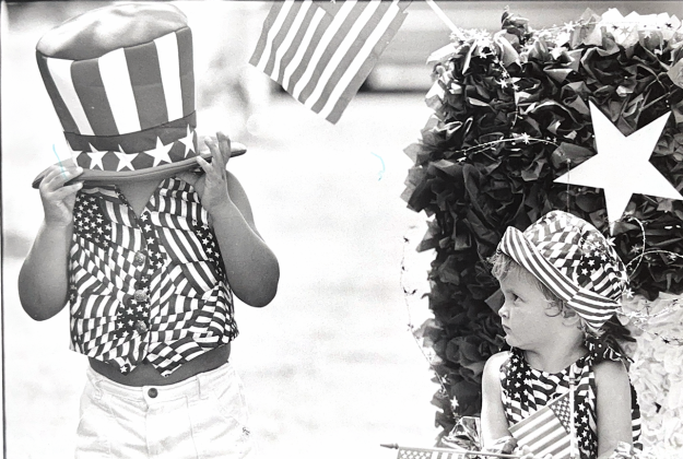 Following the 1996 July Fourth kids' parade in Georgetown, Garrett and Chyenne Daniels clown around in their patriotic attire. (Sun archive)