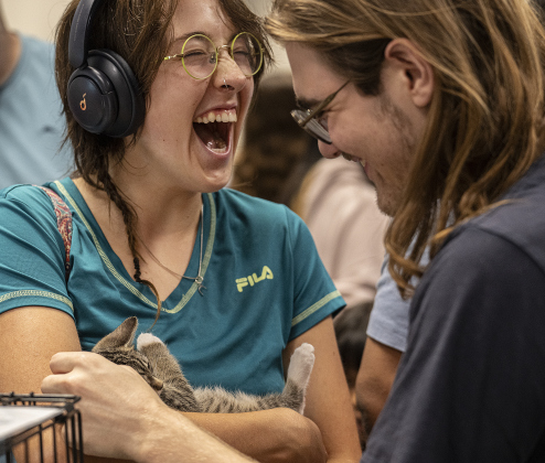 Shae Whitney, left, and Lucien Tannehill-Miyakawa are overjoyed to spend time with a kitten