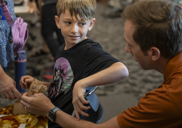 Barrett Jones, 8, and his father Philip Jones, spend time with Acadia, a kitten they adopted by during the kitten adoption event.
