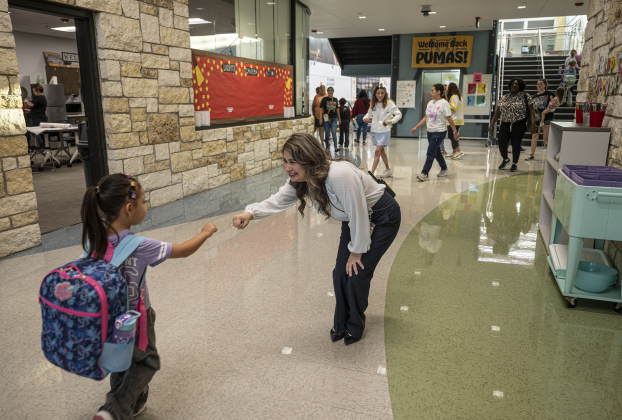 Dr. Jennifer Spears, Annie Purl principal, greets children as they enter the school on the first day of school at Annie Purl Elementary School on Thursday, August 14, 2025.  Annie Purl has 650 students enrolled this academic year.    Photo by Andy Sharp.