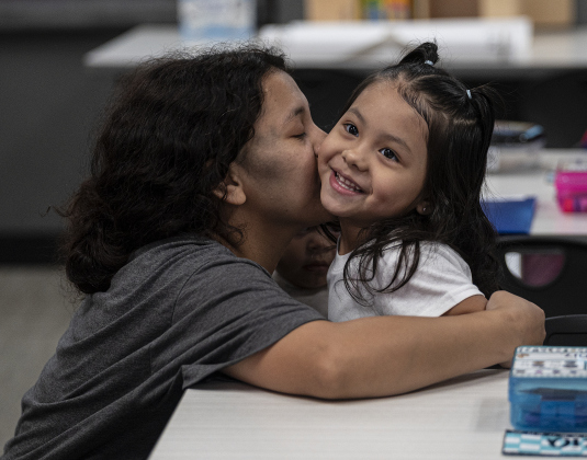 Kindergartner Analeia Alaniz, 5, gets a goodbye hug from her mom Nancy Garcia as she gets ready for class on the first day of school at Annie Purl Elementary School on Thursday, August 14, 2025.  Annie Purl has 650 students enrolled this academic year.    Photo by Andy Sharp.