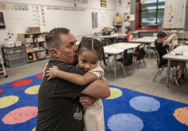 Michael Harrington gives a goodbye hug to his daughter Morgan, 5, a kindergartner, as she prepares for class on the first day of school at Annie Purl Elementary School on Thursday, August 14, 2025.  Annie Purl has 650 students enrolled this academic year.    Photo by Andy Sharp.