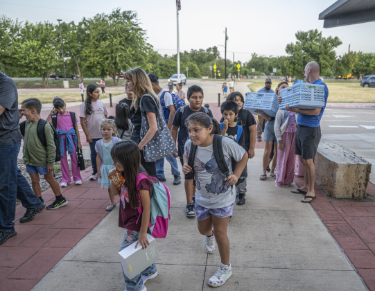 Students and their families prepare to enter the building as the doors open at 7:20 a.m. on the first day of school at Annie Purl Elementary School on Thursday, August 14, 2025.  Annie Purl has 650 students enrolled this academic year.    Photo by Andy Sharp.