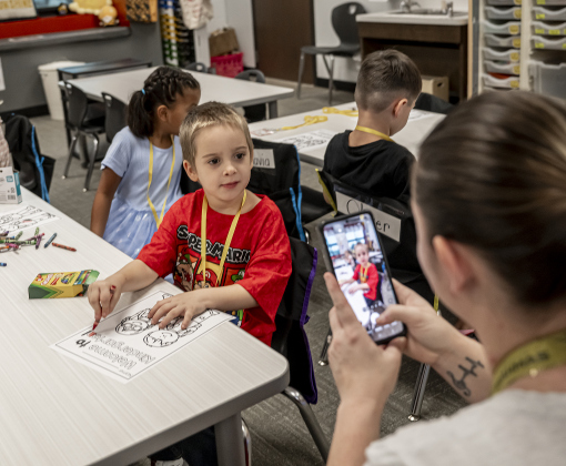 Kindergartner Nate Tafs, 5, gets his photo taken by his mom Baylee Tafs, right, on the first day of school at Annie Purl Elementary School on Thursday, August 14, 2025.  Annie Purl has 650 students enrolled this academic year.    Photo by Andy Sharp.