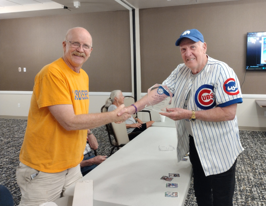 Talking Baseball’s programming director, Barry Harding (right), presents Bob Wilson with an award during the group’s August 13 meeting at The Delaney at Georgetown Village. Talking Baseball meets at The Delaney on the second and fourth Wednesday of each month. For several years, Mr. Wilson has kept his fellow participants supplied with baseball cards.