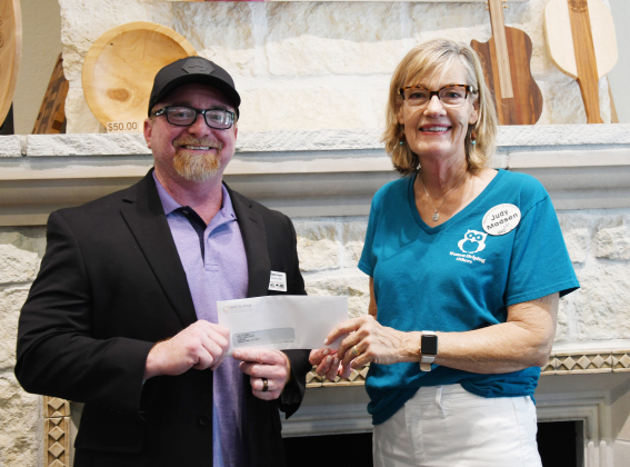 Jail To Job Program Director Eddie Franz, meets with Who Vice President Judy Madsen for a check presentation. 
