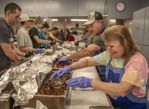 090124 GRANGER, TEXAS: Church member (and Granger mayor) Monica Stojanik, right, joins others in the parish hall kitchen preparing to-go plates for attendees at the annual church bazaar at Granger's Saints Cyril & Methodius Catholic Church on Sunday, September 1, 2024.  Members prepared meals to be distributed in to-go lines outside the parish hall, or attendees could choose to dine together inside.  There was a live auction and games, plus a dance in the parish hall on Sunday evening.  Photo by Andy Sharp