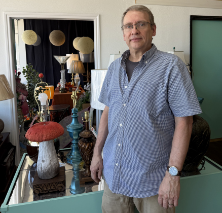 Gary McNabbstands beside a lamp he made out of a mushroom lawn sculpture. He told his wife that he can ‘make anything’ into a lamp— so she dared him to use a sculpture from their yard. Photo by Abbey Archer