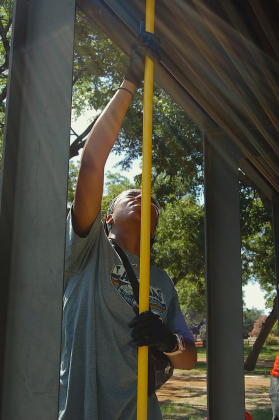 Pamela Okolie showed up to help at the Thursday, July 31 San Gabriel Park cleanup. She got rid of debris that was on top of pavilions due to the July 4 weekend flooding. (Photo by Kaitlyn Wilkes)
