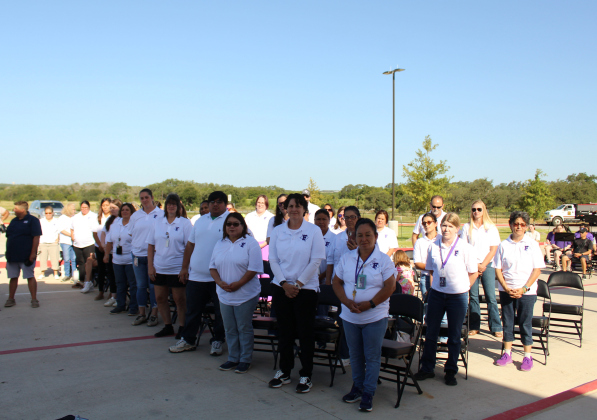 Teachers from Florence Elementary school rise as they are celebrated for teaching in the new school.