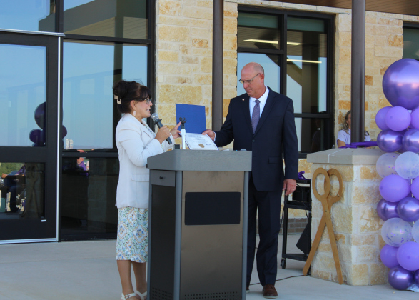 A representative from Congressman John Carter's Office presents Mr. Kirkpatrick with a flag that was flown over the Nation's Capitol during the ribbon cutting ceremony.