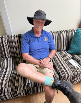 Dan Pulattie, a Georgetown Parking Ambassador, dresses to make a good impression on the Square with his Georgetown Police Department polo shirt, boots, sun hat and turquoise pizza socks. He said he doesn’t recall whether his wife or grandchildren bought the socks for him. Photo by Abbey Archer
