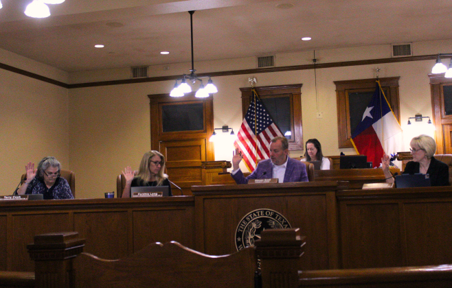 The Williamson County Commissioners Court, from left, Commissioners Terry Cook, Cynthia Long, County Judge Steve Snell and Commissioners Valerie Covey approve issuing a county-wide burn ban during the September 30 meeting. Photo by Nalani Nuylan.
