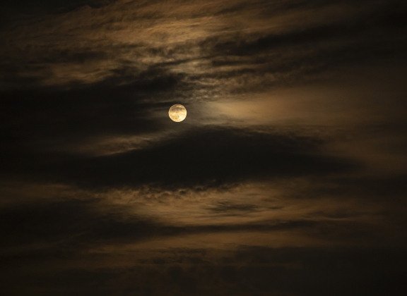 A full moon, at 99.7% visibility, goes in and out of clouds over Murphy Park  on Sunday evening, September 7, 2025.  Cloudy skies prevailed throughout the day.   Photo by Andy Sharp.