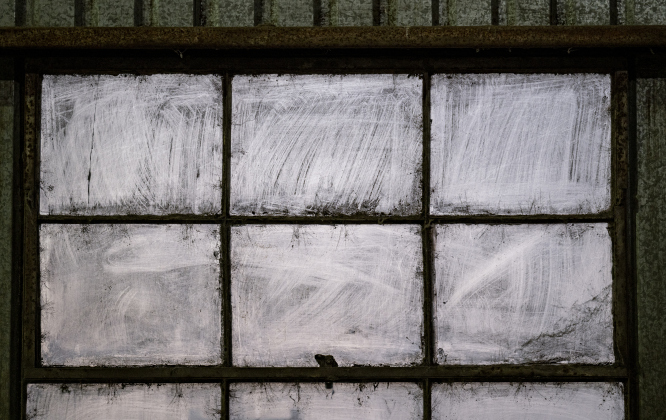 Cotton dust accumulated over years cover window panes  at Waterloo Gin on Tuesday, September 9, 2025.  The gin is along County Road 414 east of Taylor.   Photo by Andy Sharp.