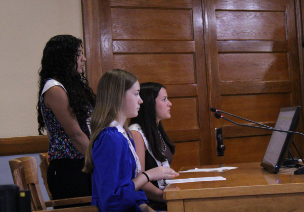 Wilco Fair and Rodeo Fair Queens, inaugural Queen Morgan Notgrass (seated back), first runner up Courtney Hall (seated front) and Alexis Zua Zua (standing back), speak about this year’s fair and rodeo during the Commissioners Court meeting on August 12. Photo by Nalani Nuylan