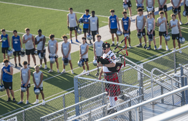 Georgetown Fire Department  Pipes and Drums member Garey Jackson plays “Amazing Grace” as members of the Georgetown High football team pause their morning practice during the Memorial Stair Climb held at Birklelbach Field,  commemorating the 24th anniversary of the attacks on United States soil on September 11, 2001.