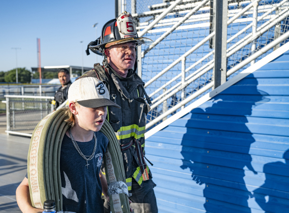 10-year-old Read Lockwood walked with his father, Georgetown Fire Department Captain Trey Lockwood during the Memorial Stair Climb held at Birkelbach Field on Thursday, September 11, 2025 to commemorate  the 24th anniversary of the attacks on United States soil on September 11, 2001.