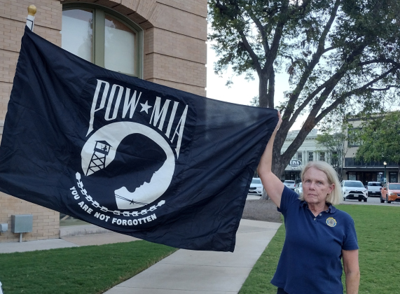 B.J. MacMillan, an Army veteran representing American Legion Post 174, displays the POW flag during a September 19 event on the east side of the Williamson County Courthouse. About 25 people attended the National POW/MIA Recognition ceremony, held each year on the third Friday in September.