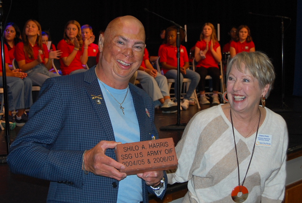 Keynote speaker Shilo Harris, right, receives a brick from Diane Klutz, the Veteran’s Memorial Advisory Group Chairwoman, that will be placed in Sun City’s Veteran’s Memorial Plaza. (Photos by Kaitlyn Wilkes)