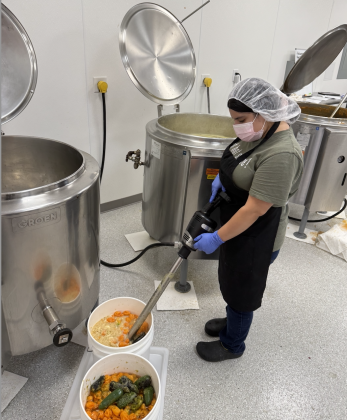 Sabrina Gonzalez, Lead Cook at Mikey V’s manufacturing facility, blends habanero peppers and garlic together to create a sauce. The current 3 kettles are 32 gallons and are going to be replaced with 132 gallon kettles.