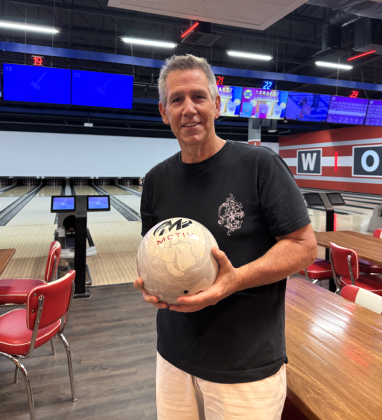 Todd Pettengill stands holding one of his bowling balls at Lucky Strike Georgetown located at 1010 North Austin Avenue. Mr. Pettengill brings a rolling bag with four balls, of varying weights, to choose from depending on lane conditions. Photo by Abbey Archer