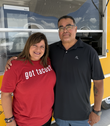 Tanya and Michael Valencia standing in front of the Mikey V’s food truck. Photo by Abbey Archer