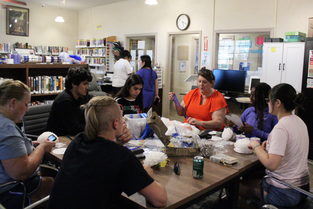 Jarrell Library Director Susan Gregurek lists the available supplies for the students to make their homecoming mums at the Jarrell Library and Resource Center’s Mum-making party, September 10.  Photo by Nalani Nuylan.