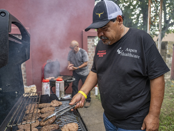 Osbaldo Kancheff, front, and Lupe Benitez, back, were manning the grills during the National Night Out observance held at the Georgetown Housing Authority’s Stonehaven site  on Tuesday, October 7, 2025.  Photo by Andy Sharp.