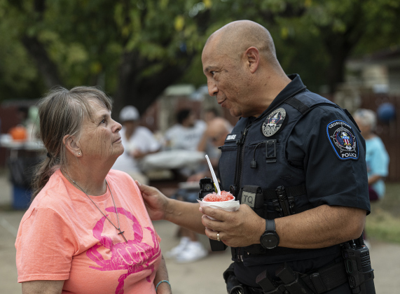 Marion Goforth, left, visited  with Georgetown Police Department officer Cesar Salinas during  the National Night Out observance held at the Georgetown Housing Authority’s Stonehaven site  on Tuesday, October 7, 2025.  Photo by Andy Sharp.