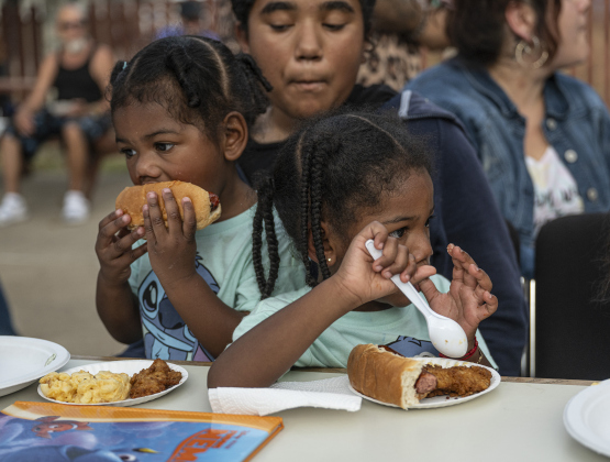 Mariella Machado, 2, left, and her sister Maylani, 3, are joined by their cousin Autumn Garcia,, center, during the National Night Out observance held at the Georgetown Housing Authority’s Stonehaven site  on Tuesday, October 7, 2025.  Photo by Andy Sharp.